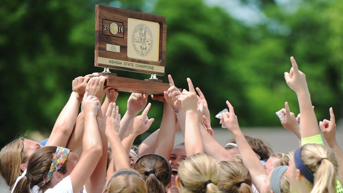Members of the Shawnee Mission West girls soccer team hoisted their state championship trophy after the Vikings won the Kansas Class 6A title match on Sunday in Junction City, Kan.