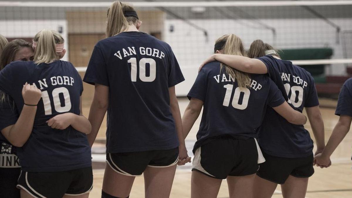 Before their first home game of the 2015 season, Heritage Christian Academy volleyball players participated in a ceremony to honor coach Janice Van Gorp.