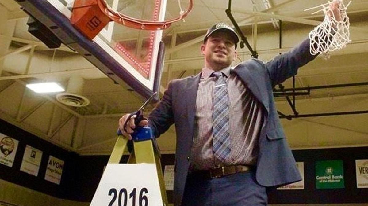 Joe McKinstry helped cut down the net after coaching the Kansas City Kansas women’s basketball team to a national title.