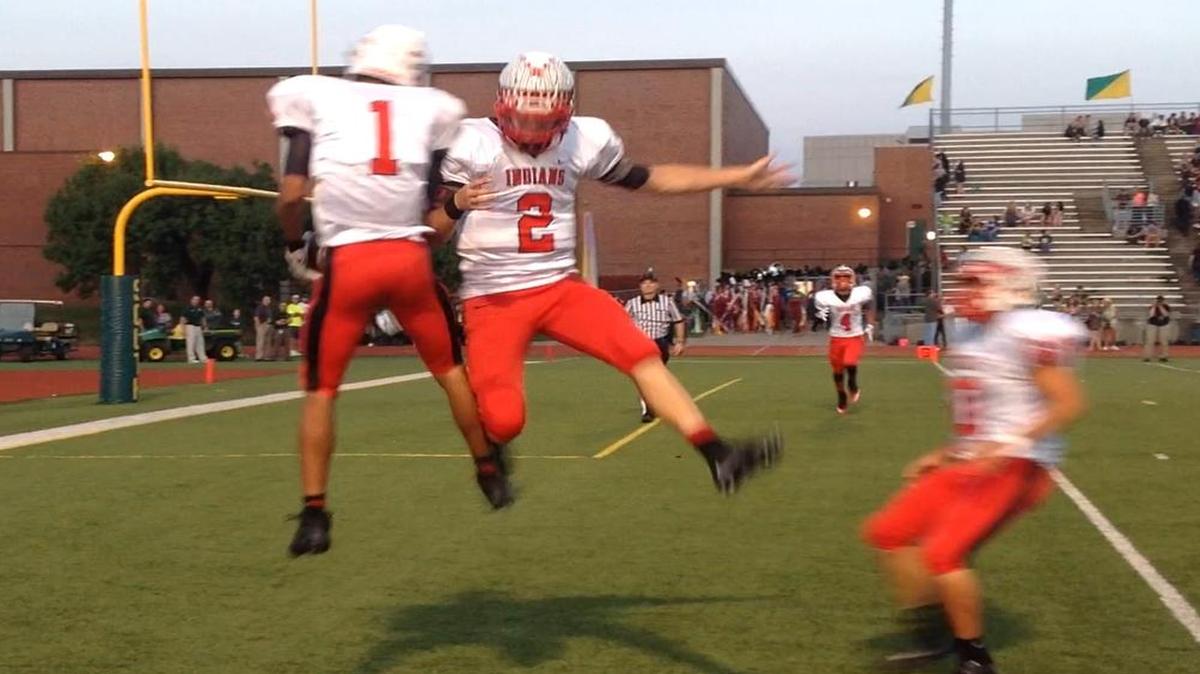 Shawnee Mission North’s Avante Williams (No. 1) and Will Schneider (No. 2) celebrated after Schneider tossed a touchdown pass to Williams during their game against Shawnee Mission South on Friday night in a Sunflower League game at SM South High School.