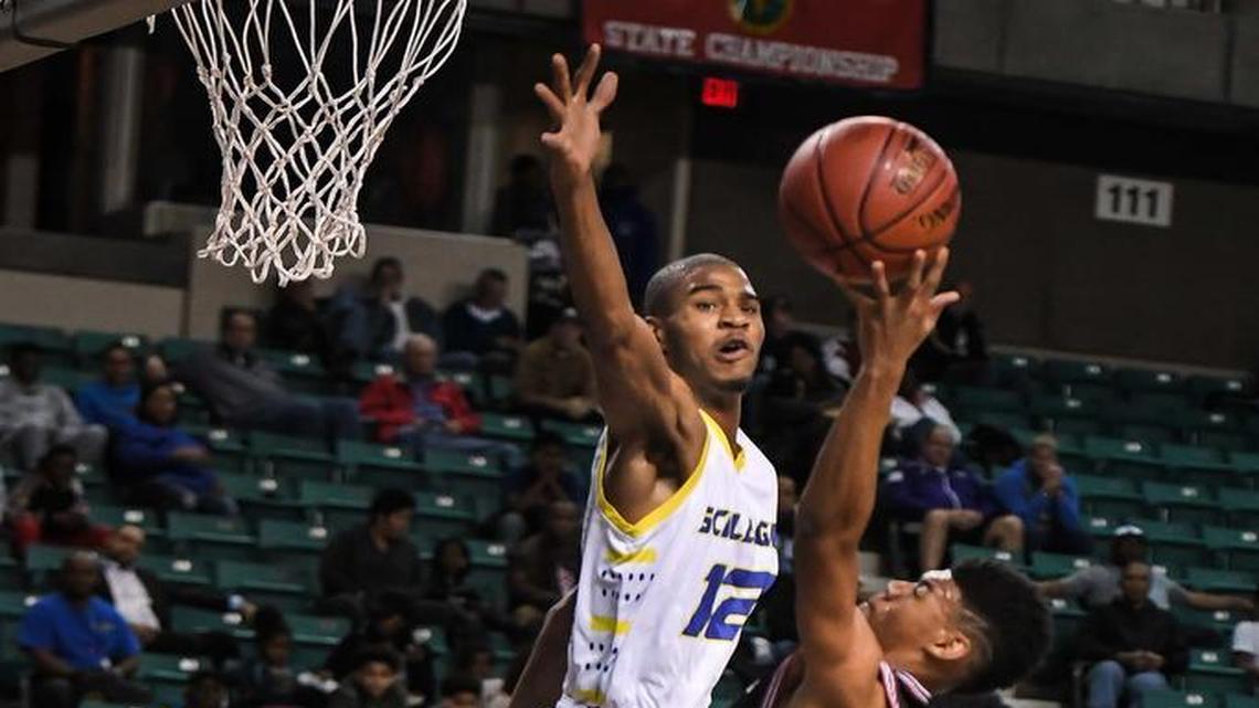 Schlagle’ Malik Cushon soared for the block against Wichita Heights’ Tyrell Andrews in Friday’s Kansas Class 5A semifinal in Topeka.