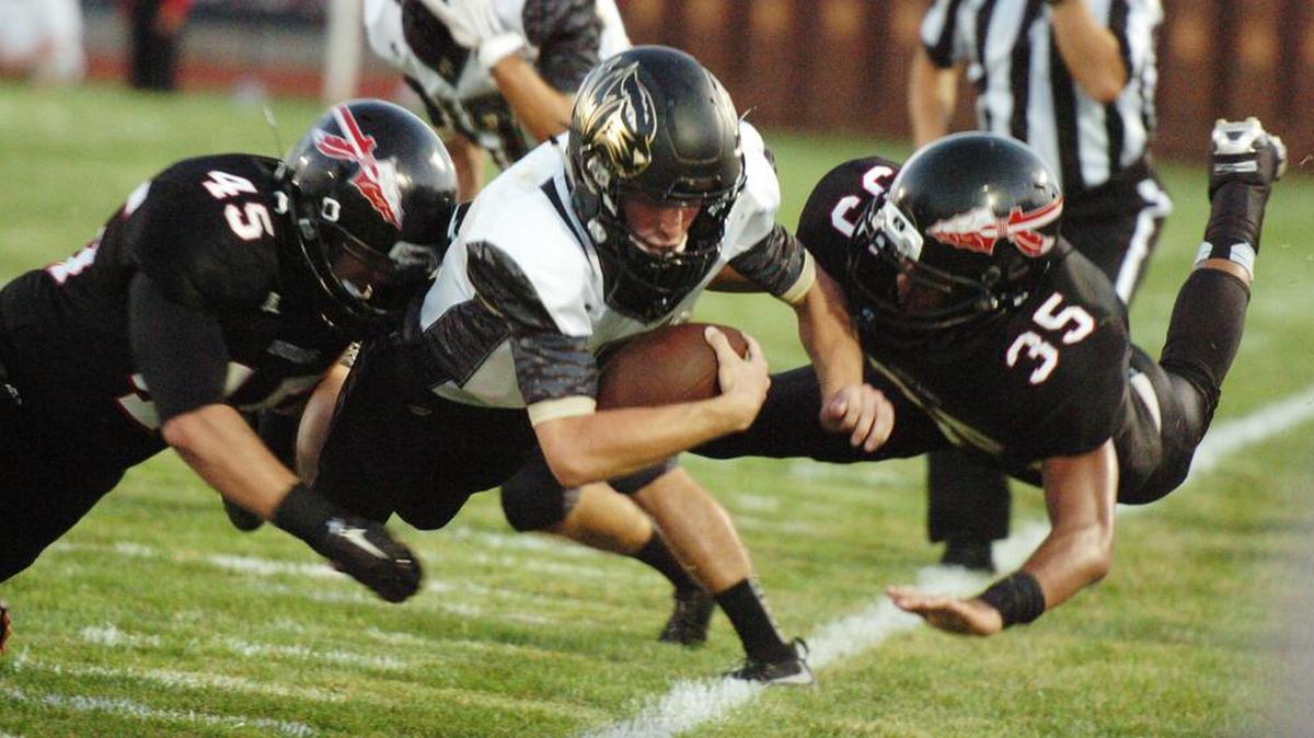 
Lee's Summit’s Dalton Hill (center) was forced out of bounds by Fort Osage’s Alec Chavez (left) and Jonah Tuimaseve during Friday night’s game at Fort Osage.
