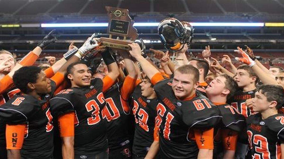 
Members of the Oak Grove football team celebrate their 49-27 victory over John Burroughs in Friday’s Class 3 Missouri state high school football championship game in St. Louis.
