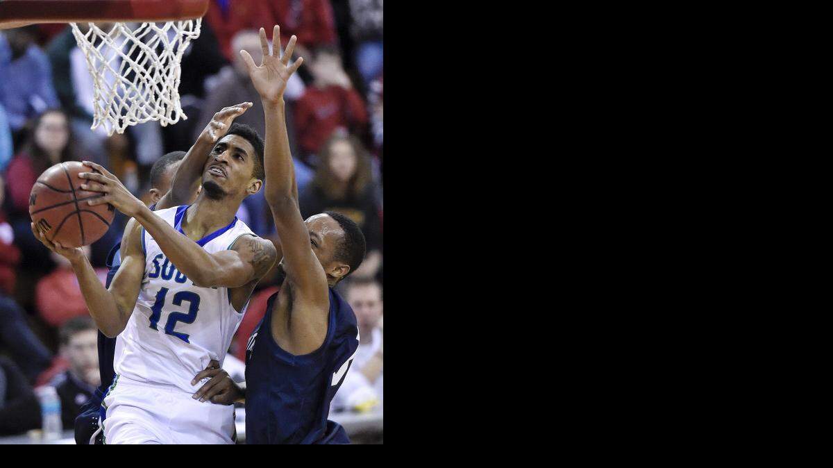
Blue Springs South guard Brandon Kilgore (with ball) found an opening between Lee’s Summit West defenders Mario Goodrich and Darius Session in their recent game in the William Jewell Holiday Classic in Liberty. Blue Springs South won the division title game, 75-53.
