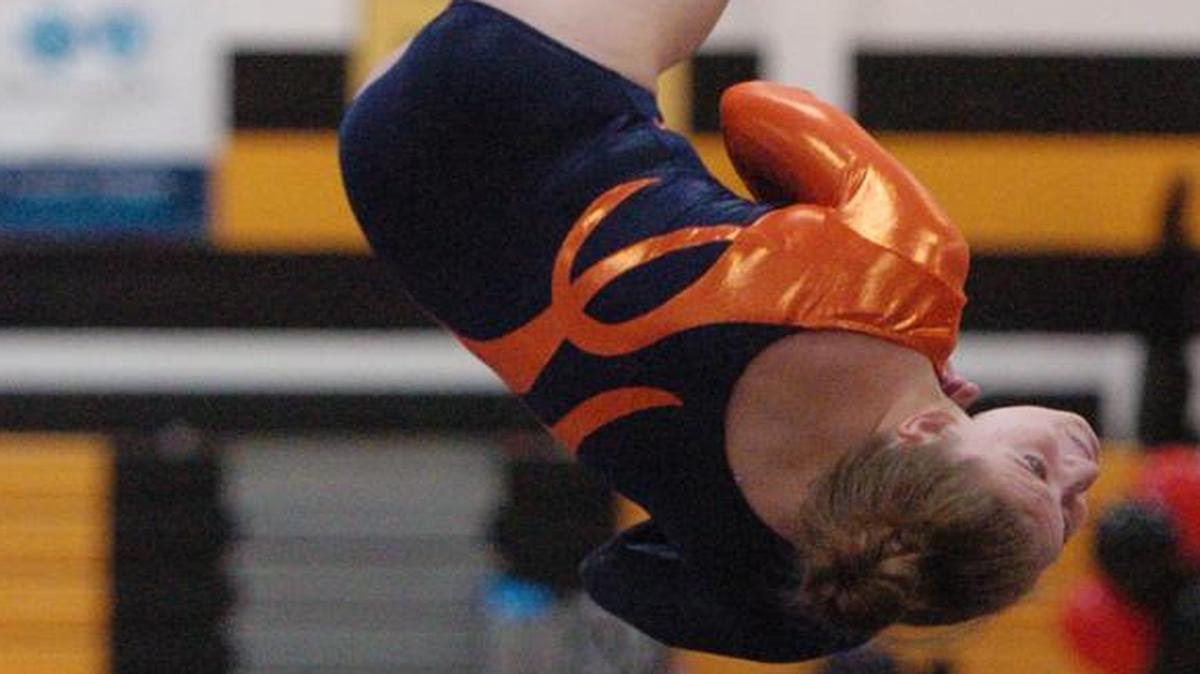 
Olathe East’s Samantha Bond dismounts from the balance beam on Saturday at the Shawnee Mission North Invitational gymnastics meet at SM West High School. She won individual titles in the all-around, vault and floor exercise.
