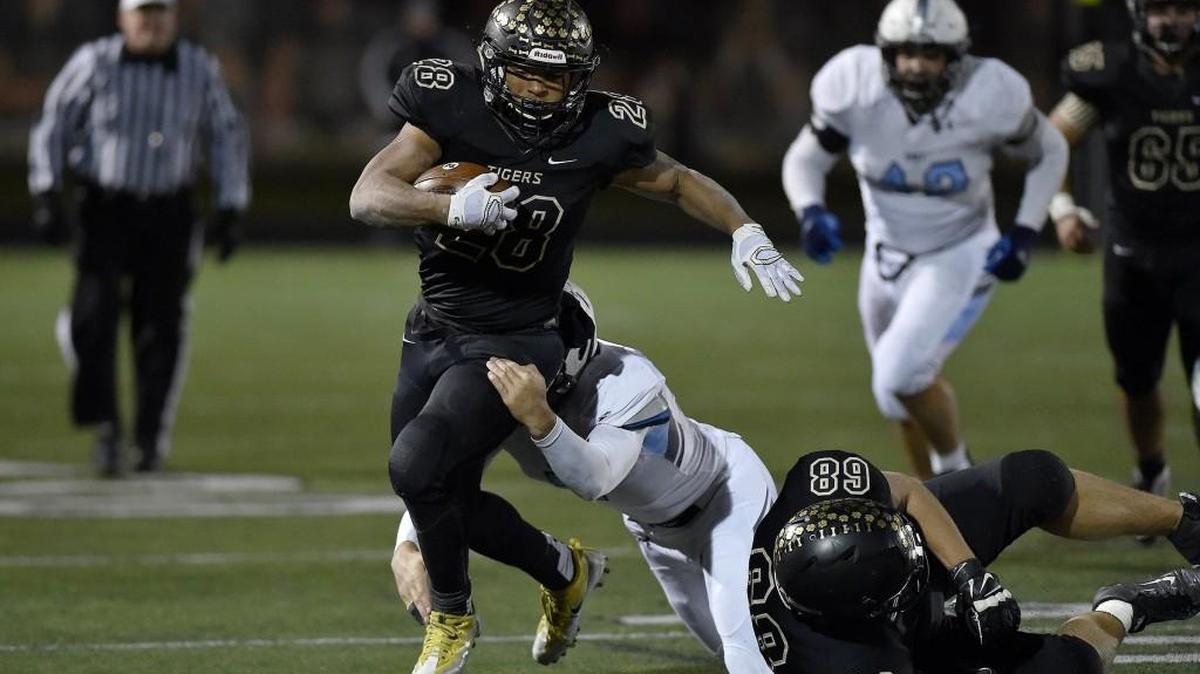 Blue Valley's William Evans scored three touchdowns in the Tigers’ 35-34 overtime victory against Shawnee Mission East in a Kansas 6A semifinal.