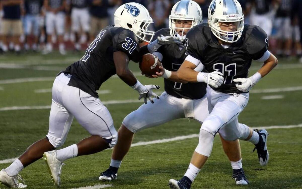 Lee’s Sumit West quarterback Cole Taylor (center) threw 12 touchdown passes last season.