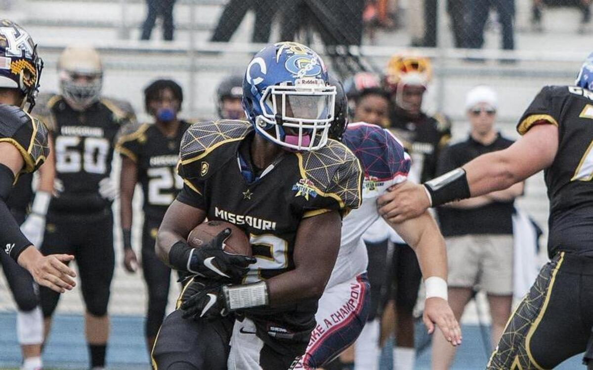 Norvell Trent of Center High School tried to evade the Kansas All-Stars defense in the Kansas vs. Missouri High School All-Star Game on Thursday night at Blue Springs South High School.