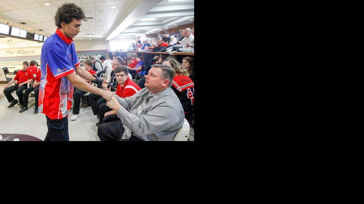 
Olathe North senior Brian McKenzie (left) was congratulated by his coach, Jim Anderson, after finishing his day on Friday at the Kansas Class 6A bowling state championships at Northrock Lanes in Wichita.
