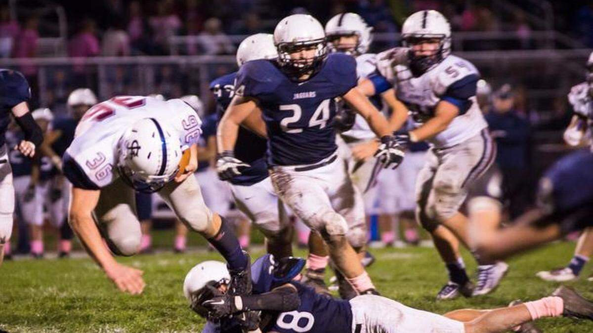 
Jake Burgmeier (St. James) at the end of a 5 yard carry tripped up by Bryan Burnett on a St. James 1 and 10 at Mill Valley's 29 yard line.
