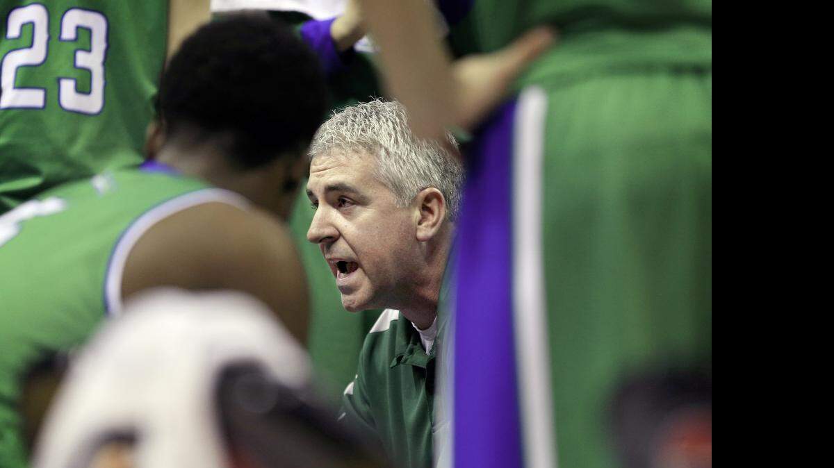 
Blue Springs South coach Jimmy Cain spoke with his boys basketball team during a timeout during the state tournament semifinal game in March at Mizzou Arena. The Jaguars went on to win the Class A state championship.
