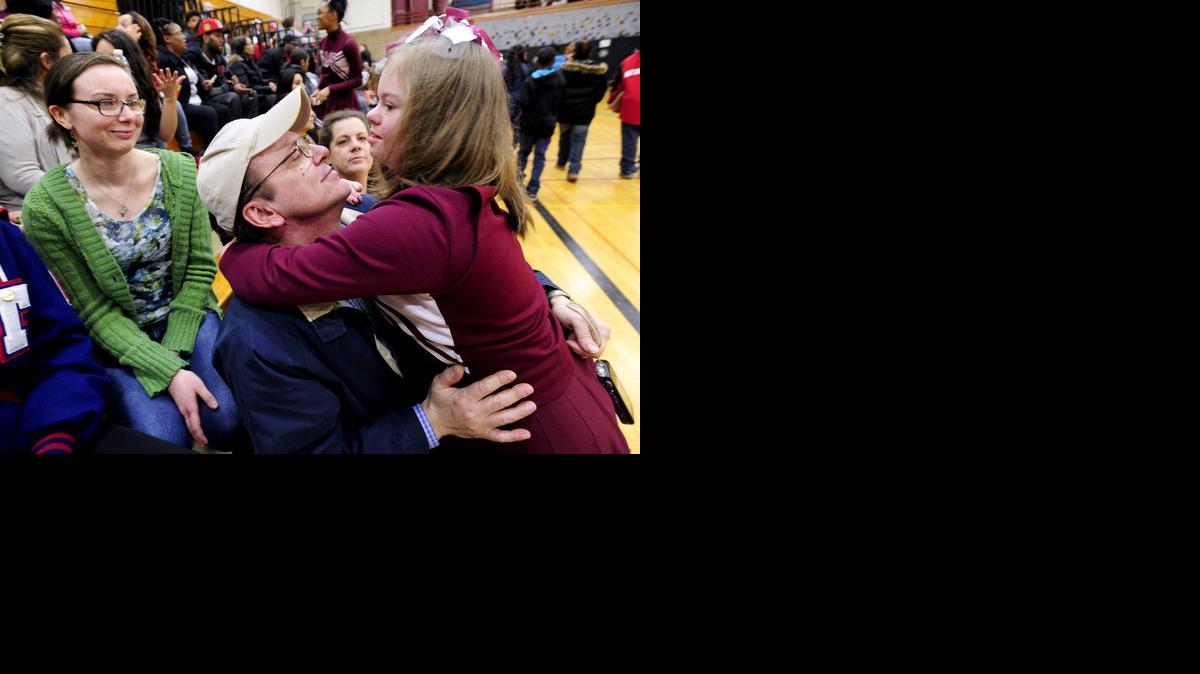 
Desiree Andrews, 14, hugs her father Cliff Andrews 

