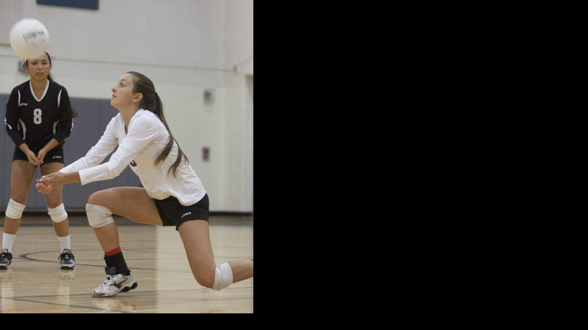
Michala Sliefert of Blue Valley Northwest returned a ball while teammate Jordan Gonzales (No. 8) looked on during the Huskies’ game against SM East in a triangular on Thursday.
