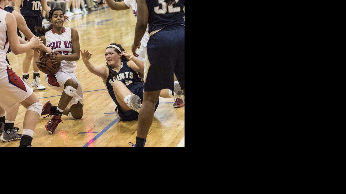 
Bishop Miege guard Hunter Bentley managed to come up with a loose ball in a battle with Claire Ferguson of St. Thomas Aquinas in their game on Friday night.
