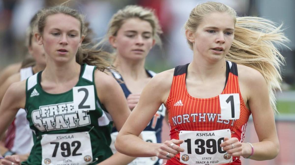 SM Northwest runner Molly Born (right) kept in front and won the 6A girls 3,200 meters during the Kansas state track meet Friday at Cessna Stadium in Wichita.