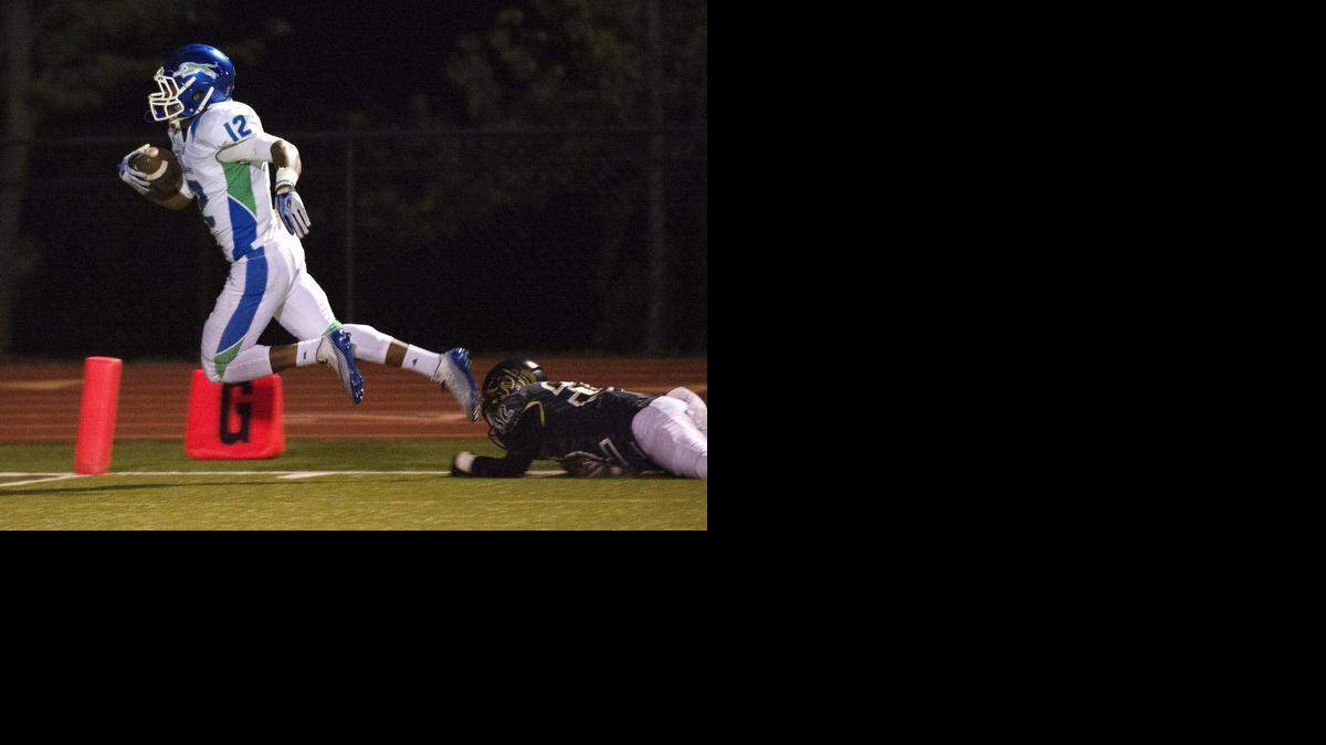 Blue Spring South’s Adam Cofield (left) got past Raymore-Peculiar defender Baylee Custer and scored a touchdown during the first half of their game Friday night at Raymore-Peculiar.