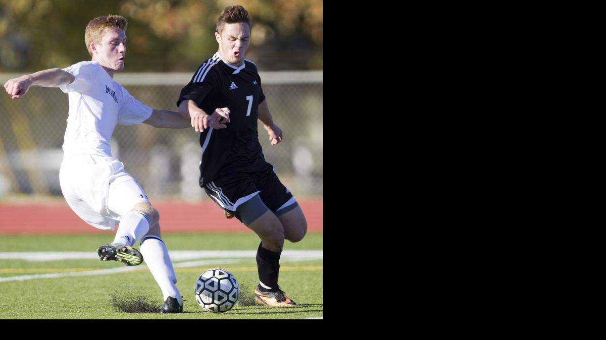 
Trevor Kerns (right), seen here against Manhattan defender Adam Gray in the 2013 state title match, is the Eastern Kansas League’s offensive player of the year.
