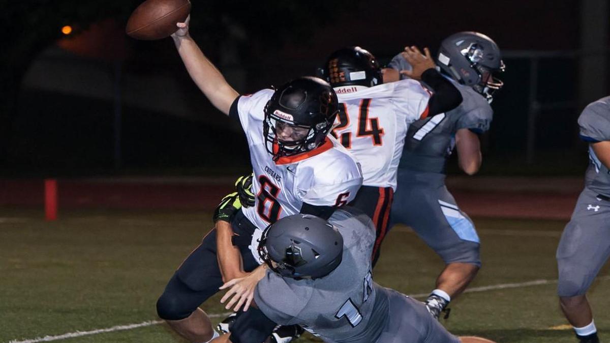 
SM East's Luke Heisdorffer (bottom) pulled down SM Northwest's Ron Kopp for a sack on Friday night at Shawnee Mission South District Stadium.
