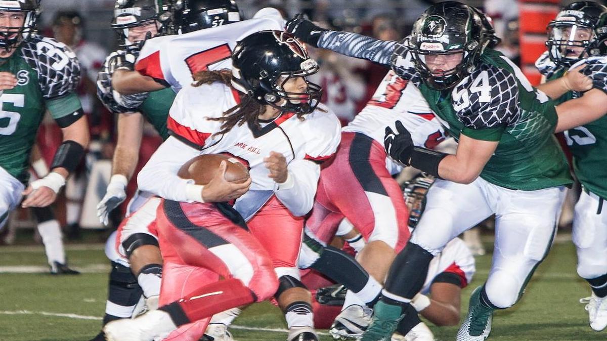 Park Hill’s back Davion Tyler turned the corner in front of Staley’s Joe McNally in Park Hill’s victory on Friday night. The Trojans defeated Staley 27-16.