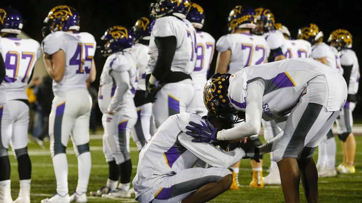 Blue Springs’ Malik Bake (right) comforted Xavier Hall after the Wildcats lost the Missouri Class 6 championship game to Christian Brothers College High School in Springfield on Saturday night.
