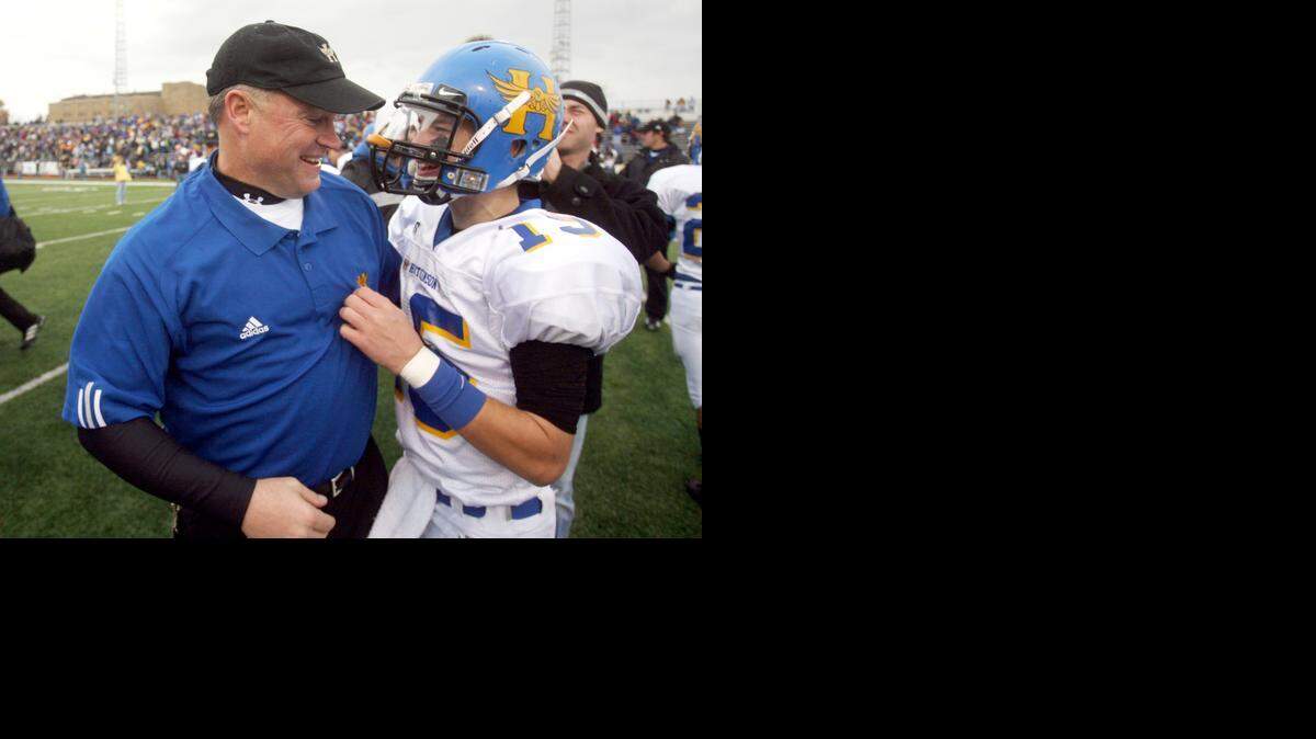 
Former Hutchinson High School football coach Randy Dreiling and his Salthawks quarterback son, Grant, are seen here after they won a state title in 2007. They hope to duplicate that feat on Saturday with St. Thomas Aquinas, where Randy is the head coach and Grant is the quarterbacks coach.
