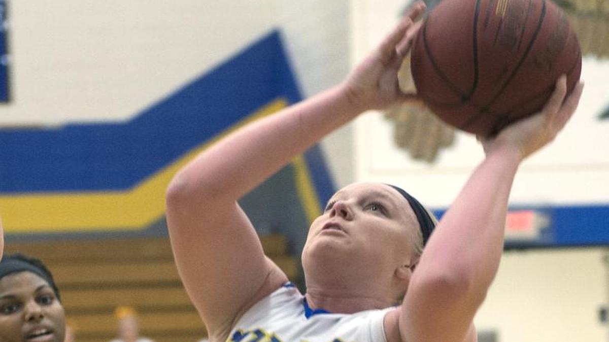 Olathe South senior Kala Holder scored a basket against Shawnee Mission North during the second half of their game on Tuesday night. It was Senior Night for the Falcons and Holder scored 25 points in a 52-42 victory.