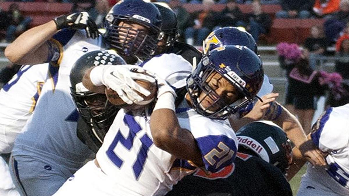 
Kearney running back Marcus Harris (No. 21) pushes his way into the end zone in the first quarter, scoring the Bulldogs’ first touchdown in their 36-0 victory over Platte County on Friday night.
