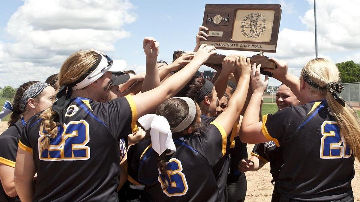 Members of the Olathe South softball team hoisted their Kansas 6A state championship trophy after defeating Washburn Rural.
