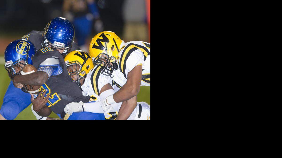 
Olathe South’s DaeVonte’ Nance was dragged down from behind by Shawnee Mission West tacklers in their game on Friday night at the Olathe District Activity Center. The Falcons defeated SM West 31-21.
