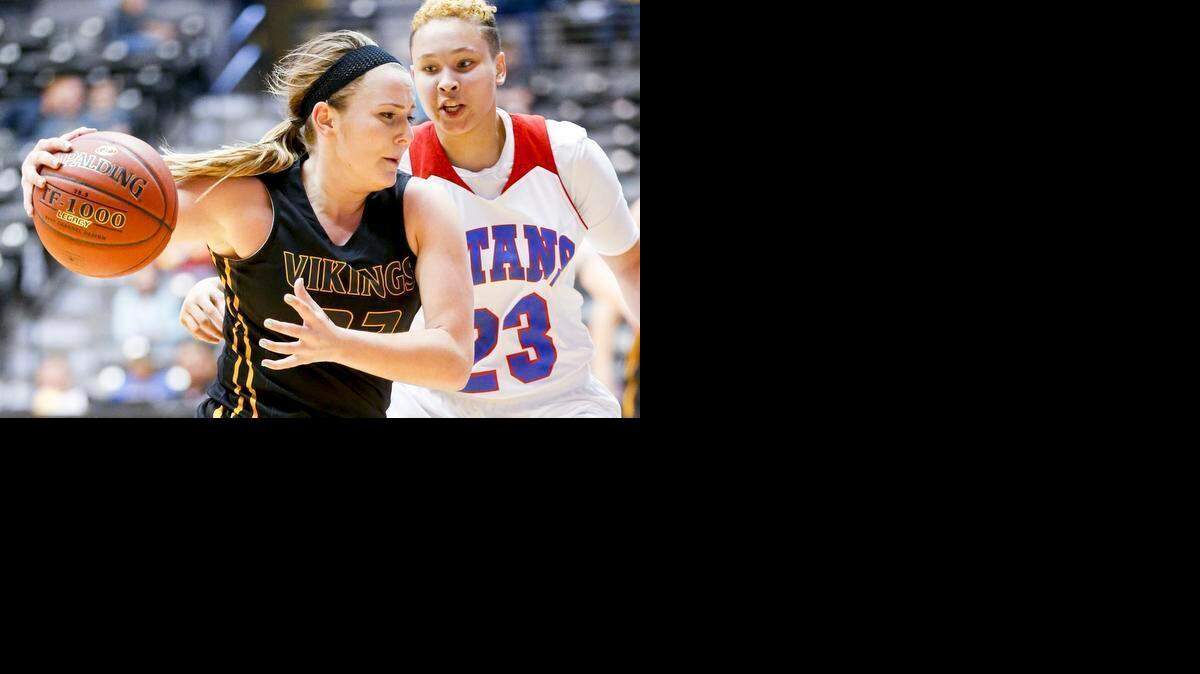 
Shawnee Mission West’s Alyx Kemp (left) worked her way to the basket against Wichita South’s Kyla Collins in the third quarter of their Kansas Class 6A state quarterfinal game on Thursday in Wichita. Wichita South beat the Vikings, 52-39.
