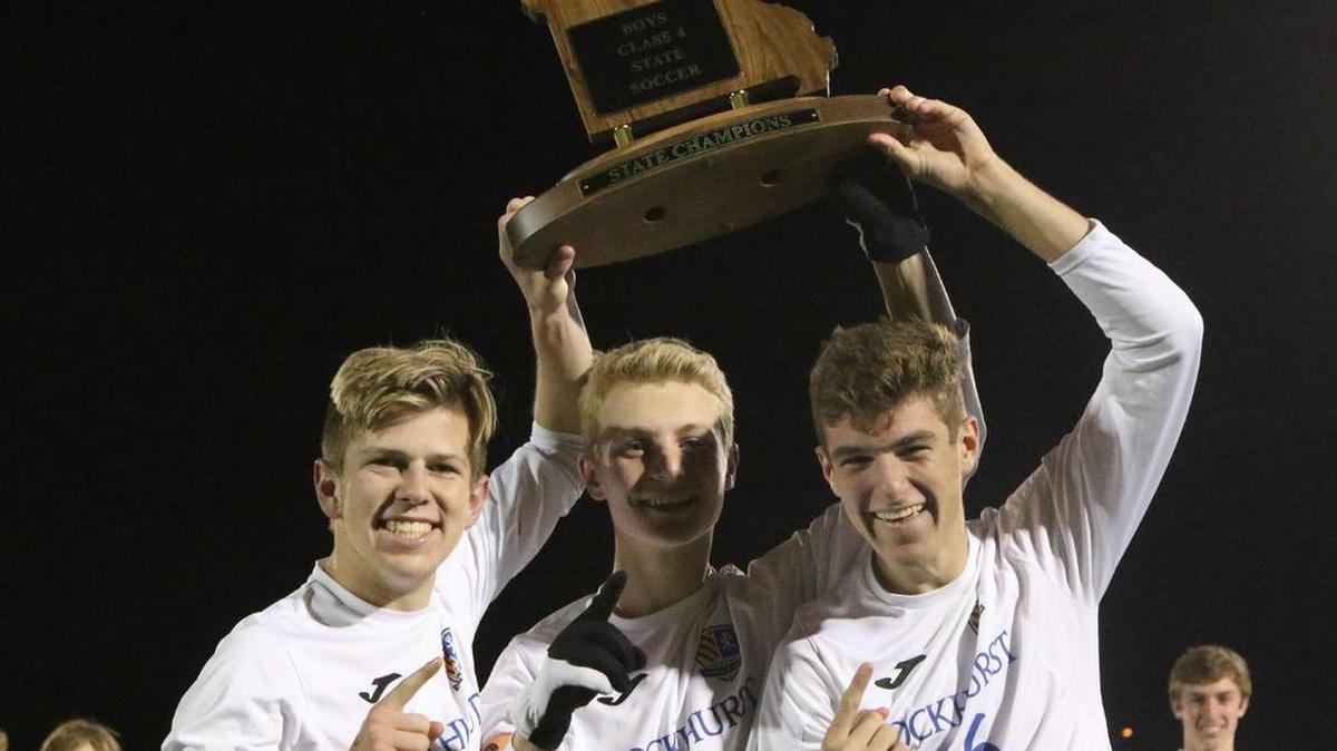 Rockhurst’s Kyle Ruark (left), George Marty and Camden Schieffer hoisted the Class 4 state soccer championship trophy on Saturday at Soccer Park in Fenton, Mo.