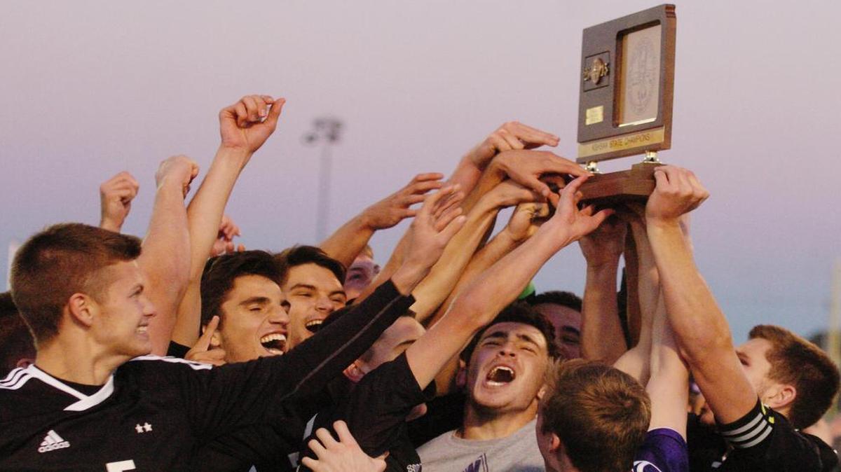 Members of the Blue Valley Northwest High School boys soccer team hoisted their state championship trophy after their 3-2 (6-5 in second round of penalty kicks) victory over Washburn Rural on Saturday in the KSHSAA soccer state tournament at the College Boulevard Activity Center in Olathe.