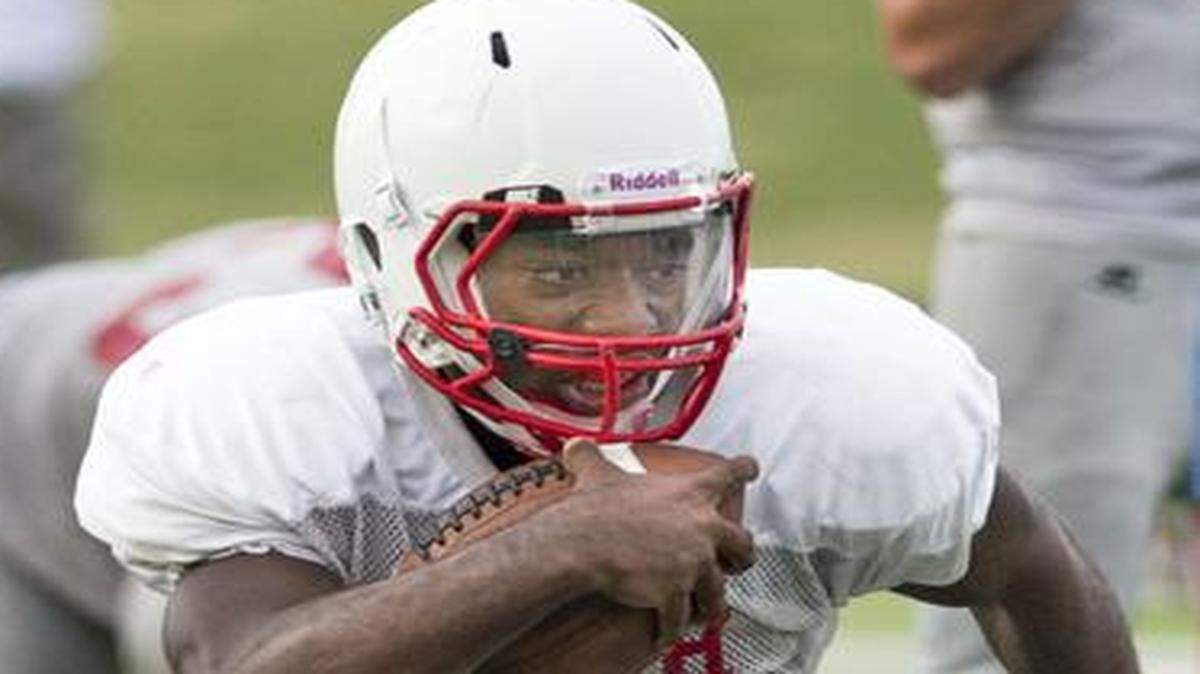 
Olathe North running back Venus Triplett looked to make a cut at football practice last month.
