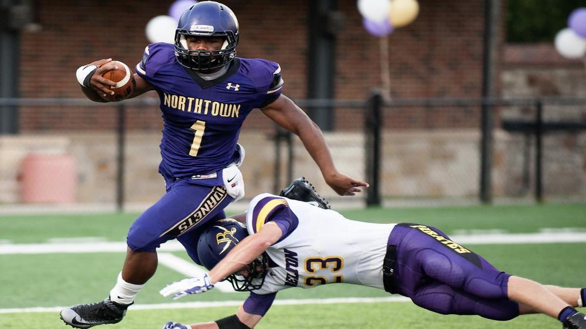 
North Kansas City High School running back Damon Whitmill looked to elude a tackle by defender Dylon Smith on Friday night during the Hornets’ game against Belton.
