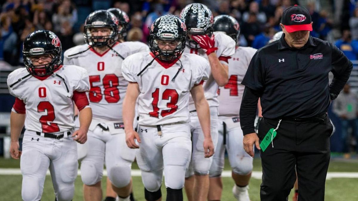 Odessa coach Mark Thomas and his Bulldogs team walked to center field in dejection after losing to John Burroughs 30-6 in the 2015 Class 3 Show-Me Bowl Championship game at the Edward Jones Dome in St. Louis.