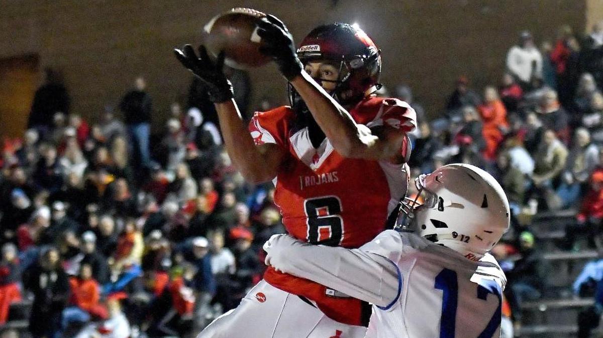 Park Hill’s Ronnie Bell catches a touchdown pass over Rockhurst’s Josh Moore during a November game.