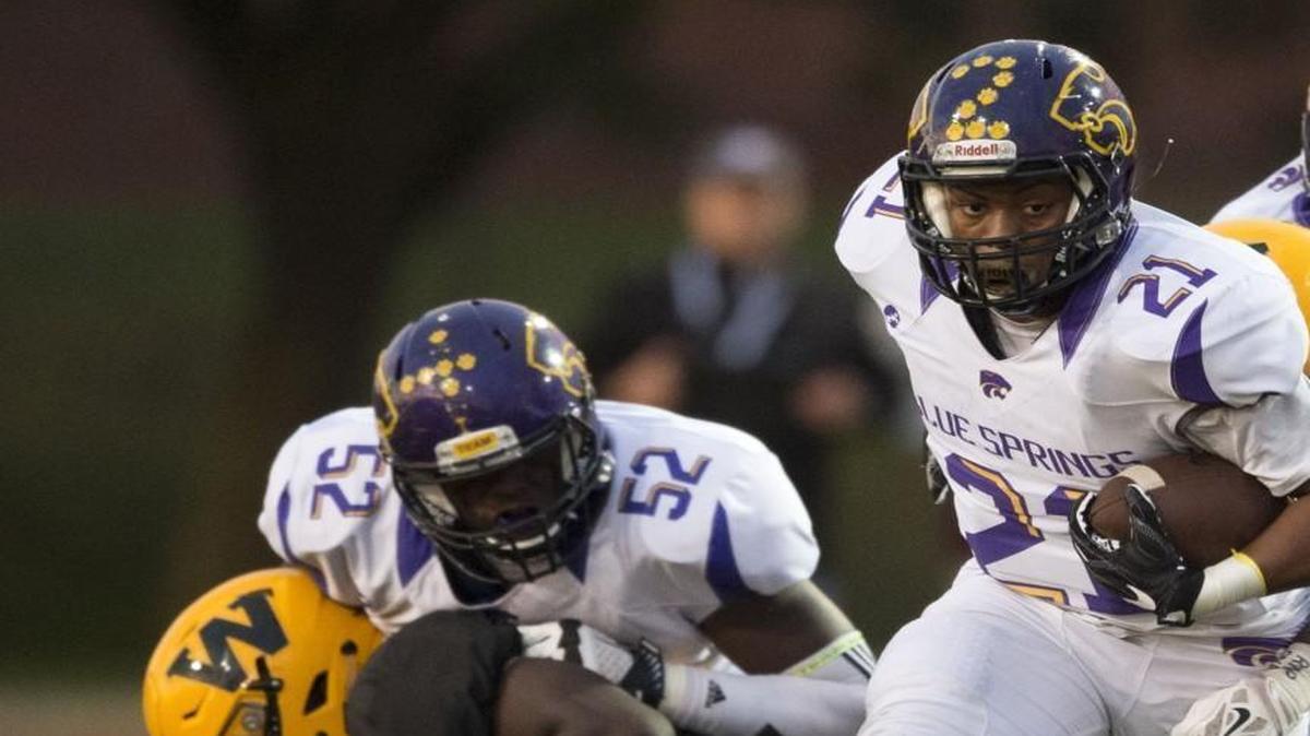 Blue Springs Jaylen Ivey (21) slipped through the line of scrimmage in the first quarter during the Shawnee Mission West and Blue Springs high school football game at Shawnee Mission South on Friday.