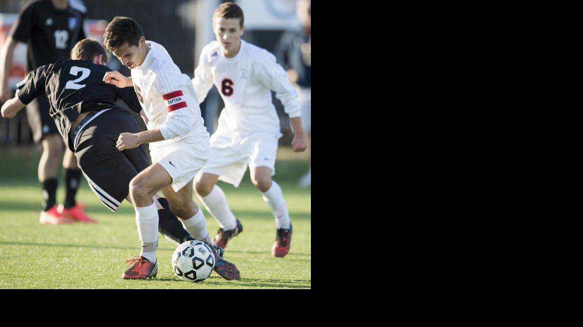 
Olathe East midfielder Mark VanLandingham (center) played a ball against Washburn Rural in the Kansas Class 6A state championship game at Hummer Sports Complex in Topeka. Olathe East won the match, 2-1.
