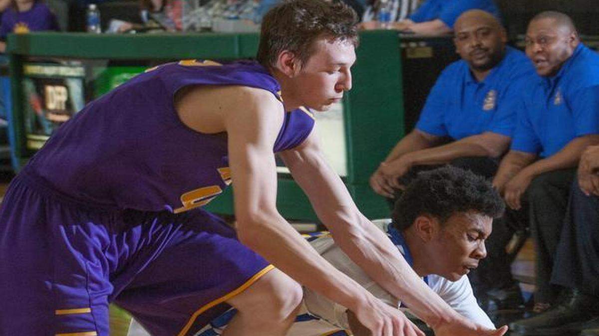 
After trailing Lincoln Prep in the first three quarters of the Missouri Class 4 sectional playoff game, Kearney rallied in the fourth quarter to win the game Tuesday night at Staley High School. Cameron Miller of Kearney (left) made a dive for a loose ball.
