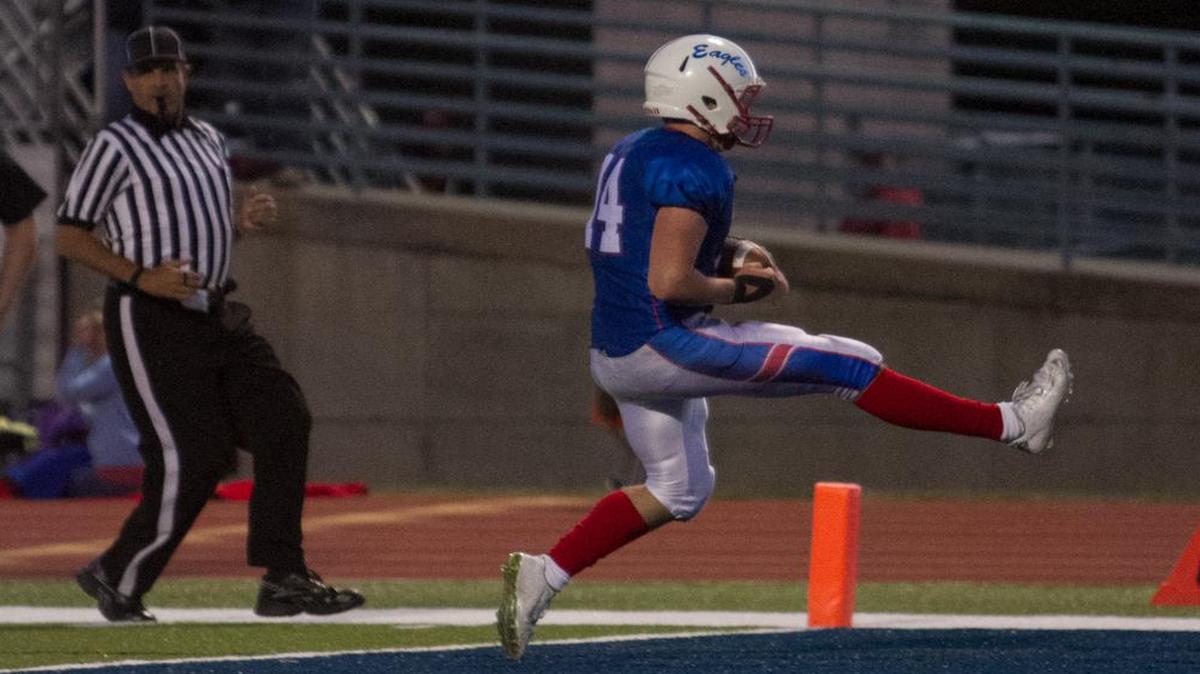 
Senior quarterback Matt Wright of Olathe North high-steps it into the end zone on a 19-yard scoring run just before halftime of the Eagles’ game against Lawrence Free State on Friday night.
