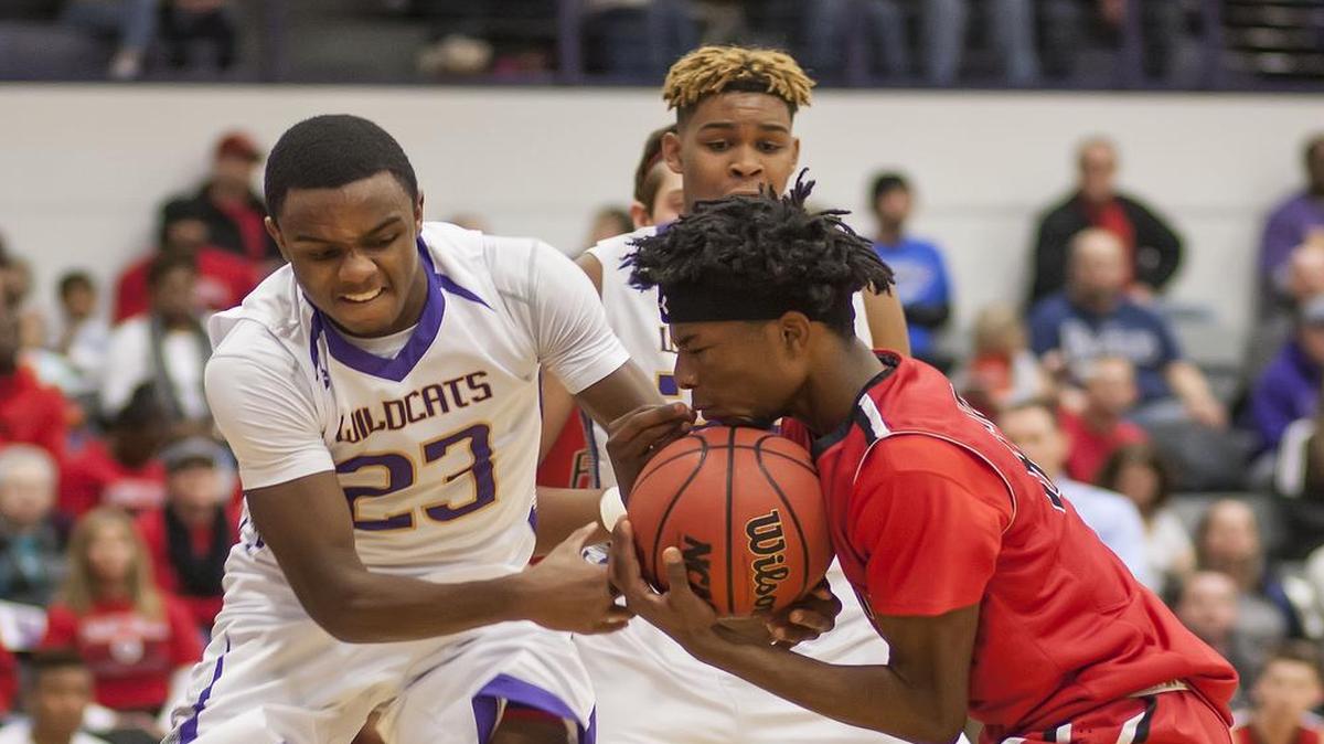 Blue Springs’ Tyree King (left) and Dru’ Smith of Park Hill battled for a rebound during their basketball game on Friday night at Blue Springs High School. The Wildcats defeated Park Hill, 74-59.