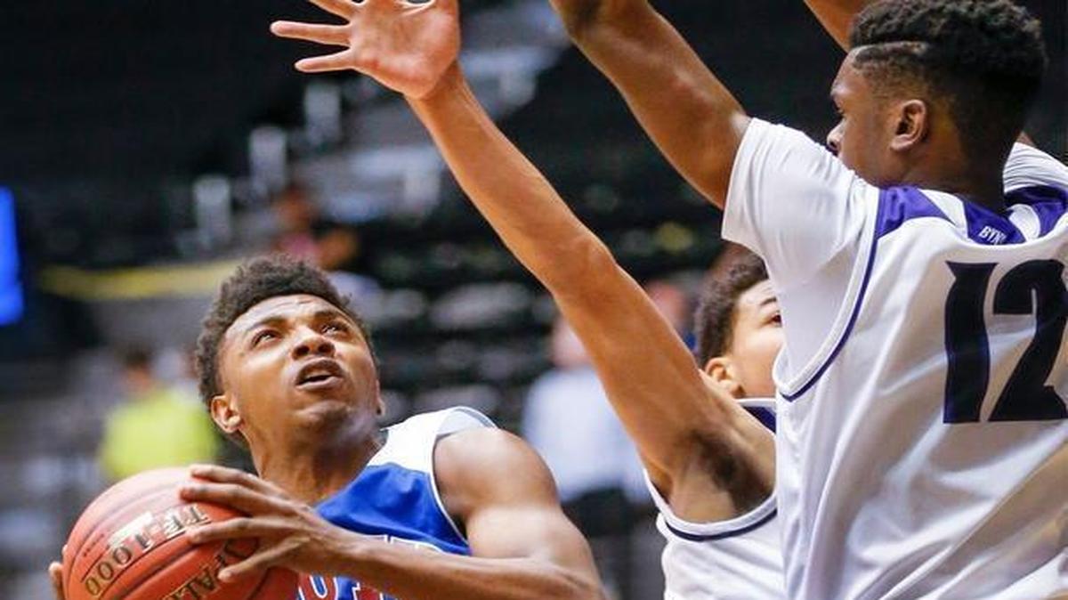 Wichita South’s Dawson Gunter (left) ran into a Blue Valley Northwest wall that included Jamichael Morgan (right) in quarterfinals action on Thursday in Wichita.