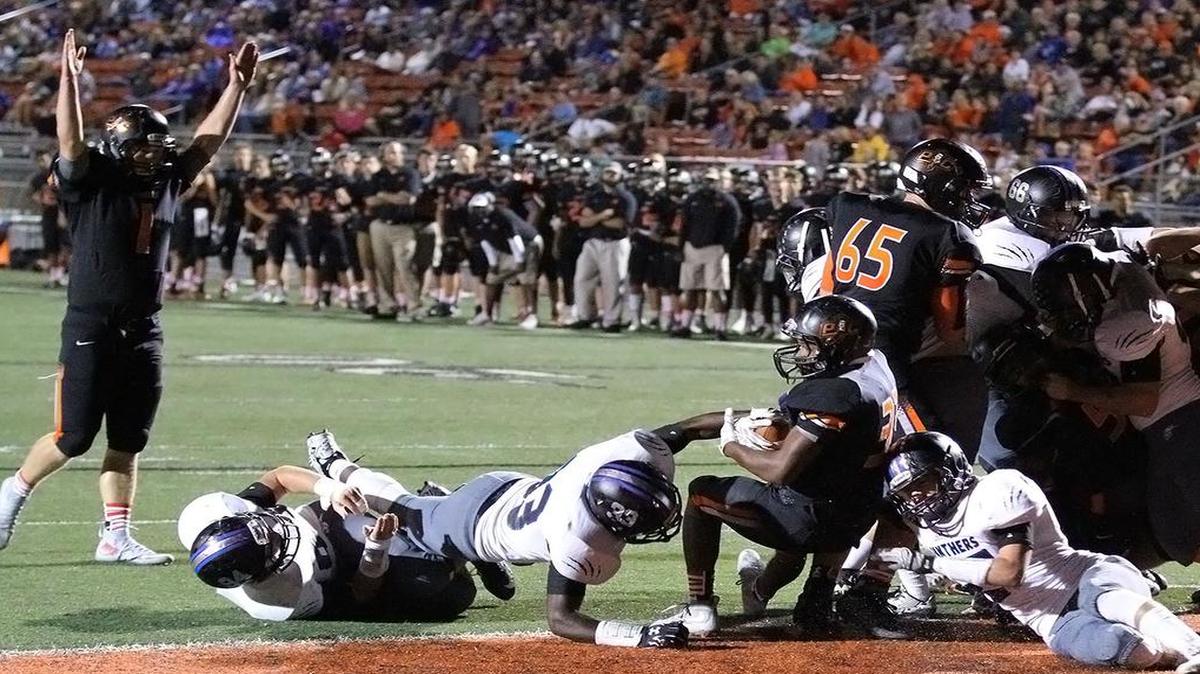 
Mike McNair of Platte County scores a touchdown on a one-yard run on Friday night against Park Hill South as teammate Justin Mitchell (No. 1) celebrates.

