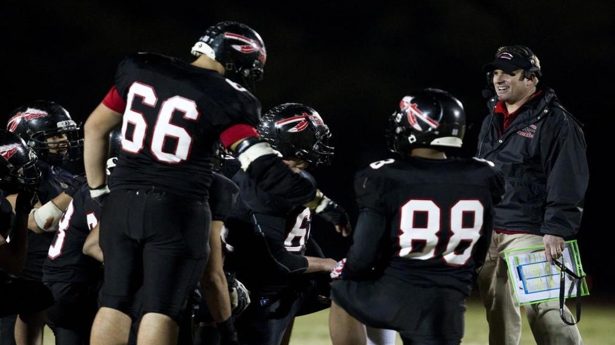 Fort Osage head coach Ryan Schartz (right) smiled as he talked to the offense during a game in 2012.