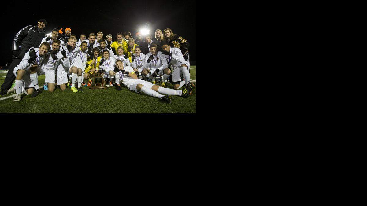 
The Lee's Summit Tigers gathered around the championship trophy after defeating the Chaminade Red Devils in penalty kicks on Saturday in the MSHSAA Class 4 boys soccer championship soccer match at Blue Springs South High School.
