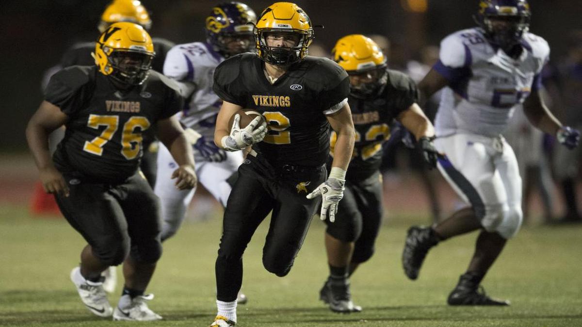 Shawnee Mission West’s Jason Meeker (with football) scored a touchdown in the second quarter in the Vikings’ game on Friday night against Blue Springs. SM West led at the half, but Blue Springs rallied for a 35-21 victory.