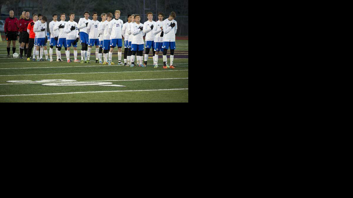 
St. Pius X players lined up for the National Anthem before the start of their state semifinal match against Perryville. 
