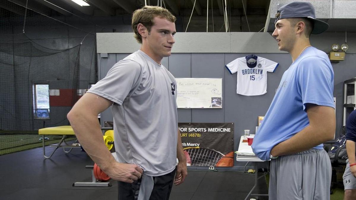Joey Wentz (left), a pitcher for Shawnee Mission East and Riley Pint, a pitcher for St. Thomas Aquinas, talked in April.