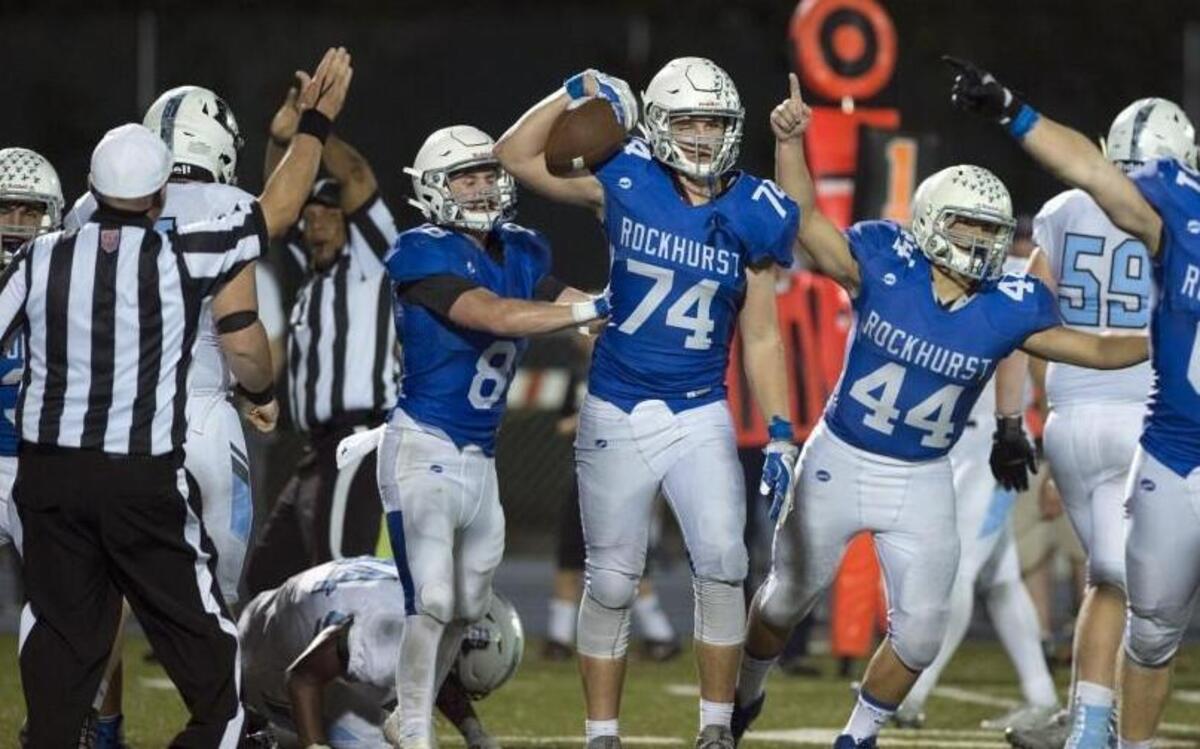Rockhurst’s Cameron Reller (center) recovered a Shawnee Mission East fumble in the fourth quarter on Friday night. In all, Rockhurst forced six turnovers from the Lancers.