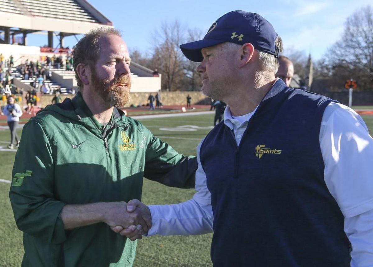 Bishop Carroll head coach Dusty Trail shakes hands with St. Thomas Aquinas head coach Randy Dreiling after Carroll’s 38-28 win in the 5A state title in Pittsburg on Saturday.